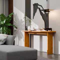 Modern living room with a gray sofa, wooden console table, and decorative items.