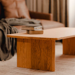 Wooden coffee table with books in a living room setting