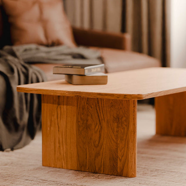 Wooden coffee table with books in a living room setting