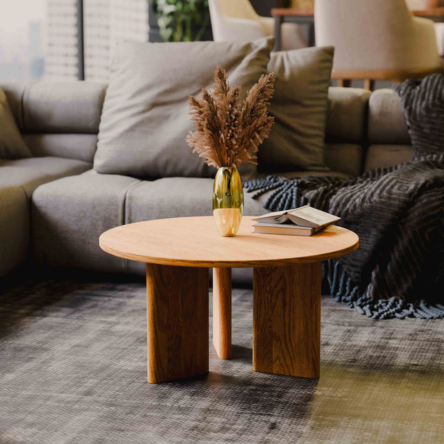 Solid wood coffee table with decorative items in a living room setting