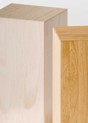Two wooden blocks with different finishes on a light gray background