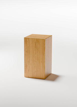 Solid oak end table styled as a small accent table in a cozy living room with neutral decor and soft lighting