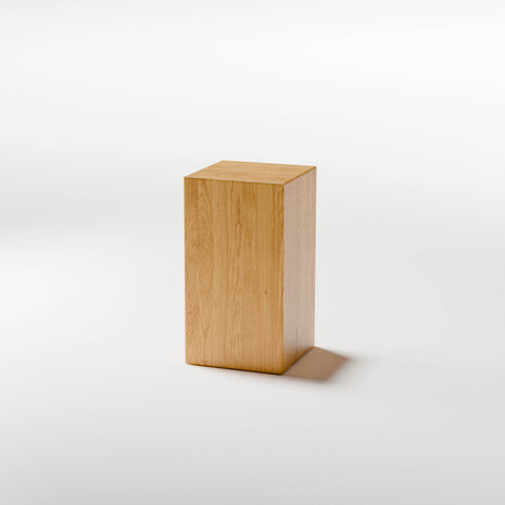 Solid oak end table styled as a small accent table in a cozy living room with neutral decor and soft lighting