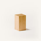 Modern solid wood side table close up detail highlighting visible wood grain and smooth hand finished surface