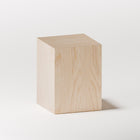 Minimalist solid wood stool in maple used as a bedside table, paired with a lamp and book in a cozy bedroom setting