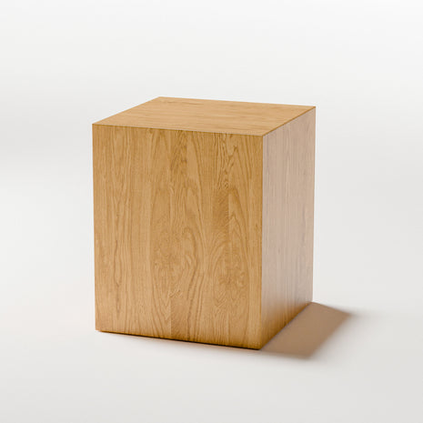 Modern solid wood stool styled as a plant stand in a bright living space, showcasing natural hardwood texture and warm tone