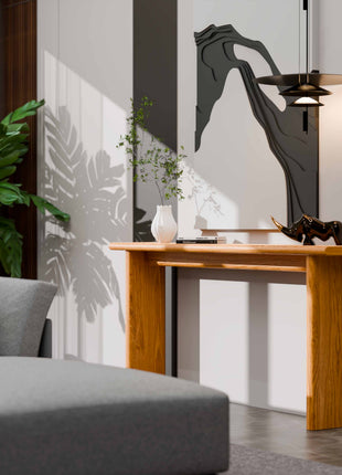 Modern living room with a gray sofa, wooden console table, and decorative items.