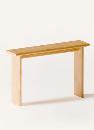 Modern solid wood console table in oak shown from a front view, emphasizing clean profile and seamless wall mounted design