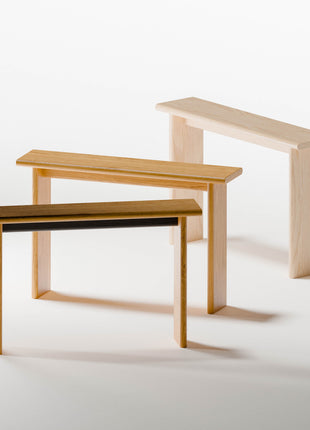 Three solid wood console table of different sizes on a white background