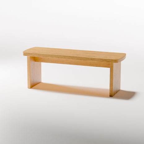 Modern solid wood nightstand styled in an entryway as a small side table, holding a bowl and decorative vase in a minimalist home