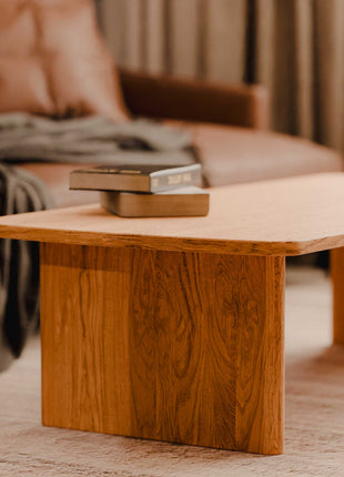 Wooden coffee table with books in a living room setting