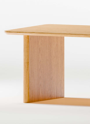 Closeup of solid wood table with a minimalist design on a white background