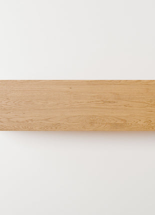 Modern solid wood console table in oak shown from front view, emphasizing clean profile and balanced proportions in a minimalist home