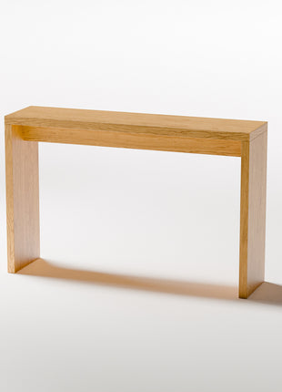 Modern solid wood console table in oak shown from front view, emphasizing clean profile and balanced proportions in a minimalist home