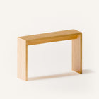 Modern solid wood console table in oak shown from front view, emphasizing clean profile and balanced proportions in a minimalist home