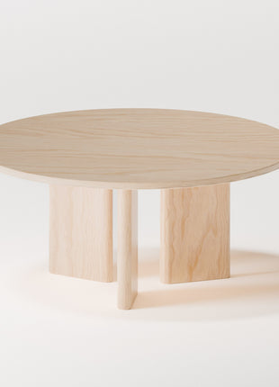 Minimalist solid wood coffee table in maple with simple rectangular shape, styled in a bright living room with modern wood furniture