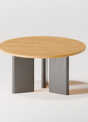 Modern solid wood coffee table in oak with clean lines and natural grain, centered in a minimalist living room with a neutral sofa and soft area rug