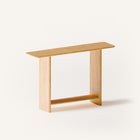 Modern solid wood console table in oak shown from front view, emphasizing clean profile and balanced proportions in a minimalist home