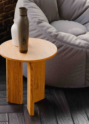 Modern solid wood end table in oak with clean lines and natural finish, styled beside a sofa in a minimalist living room
