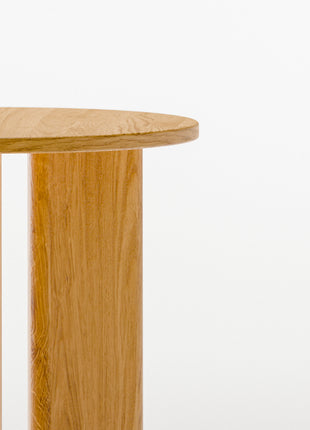 Modern solid wood side table close up detail highlighting visible wood grain and smooth hand finished surface