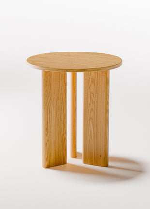 Solid oak end table styled as a small accent table in a cozy living room with neutral decor and soft lighting