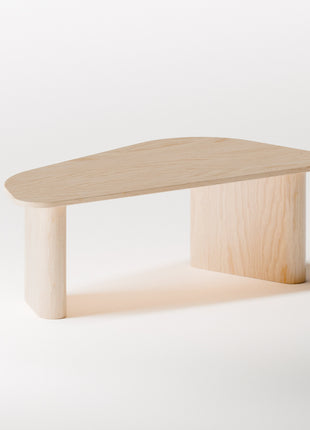 Modern solid wood coffee table in maple with clean profile and natural finish, photographed from above to show spacious tabletop surface